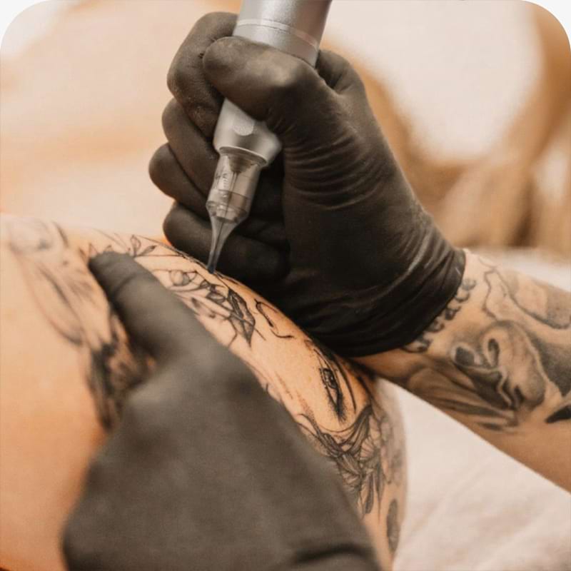 Professional tattoo artistry demonstration black gloves